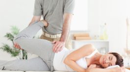 Woman's leg stretched by chiropractor